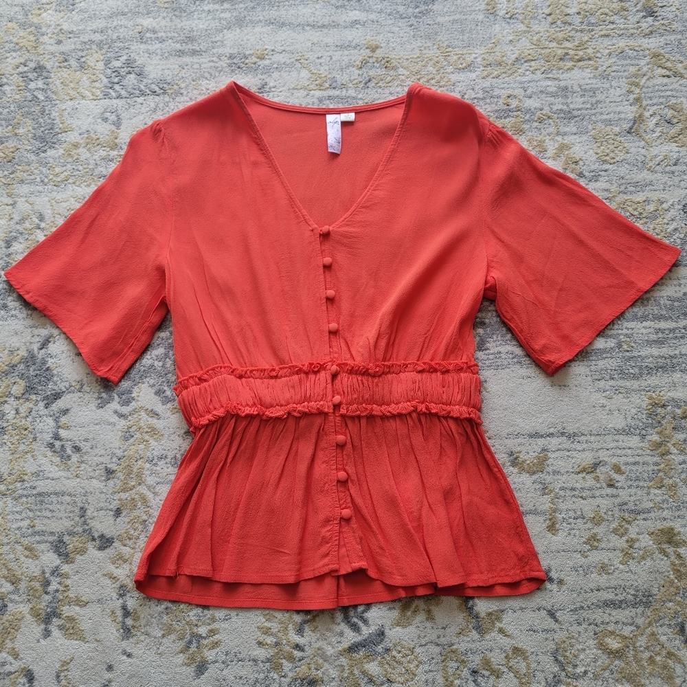 Francesca's orange blouse